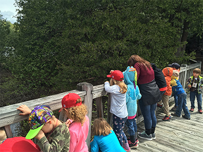 kids looking over a bridge