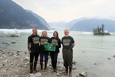 David Rak, Paula Rak, Kate Dukette, and Victoria Houser holding E S F flag at Stikin River