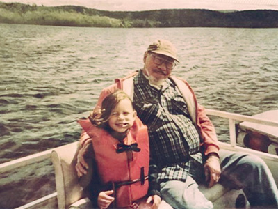 Lindsay Eberhart as a little girl with her grandfather on a boat