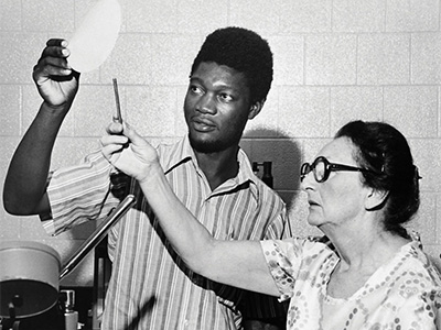 Faculty and student looking at a paper sample