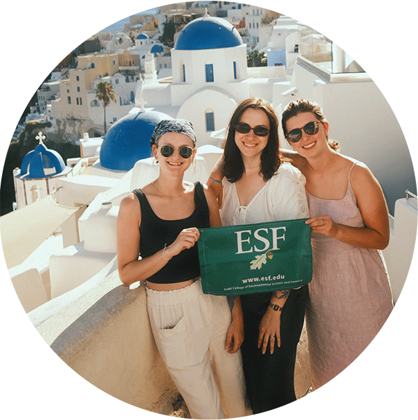 three women in greece posing with a green esf flag