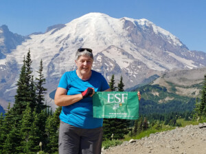 Denise Hobson (EFB) brings her ESF flag on all of her travels. Here she is most recently at Mt. Rainier in Washington state.