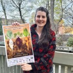 Kristine Ellsworth holding a poster of root vegetables