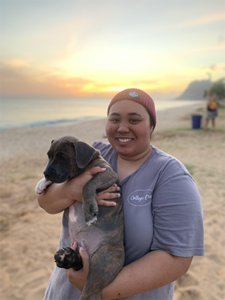 navares in a beach during sunset holding a dog