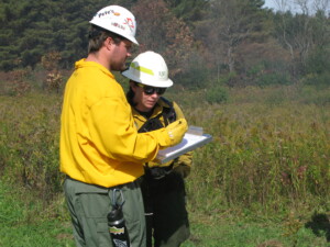 Student taking reading at the controlled burn site
