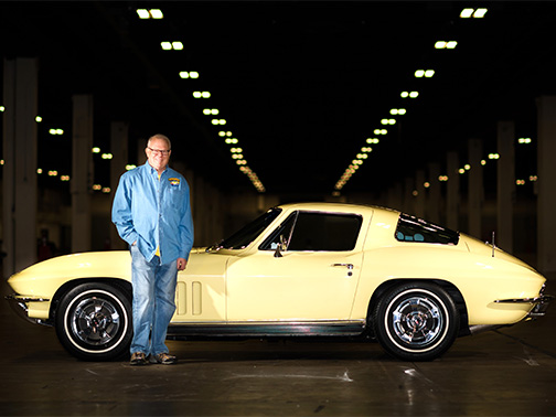 Bob Kinstrey standing next to a vintage yellow car