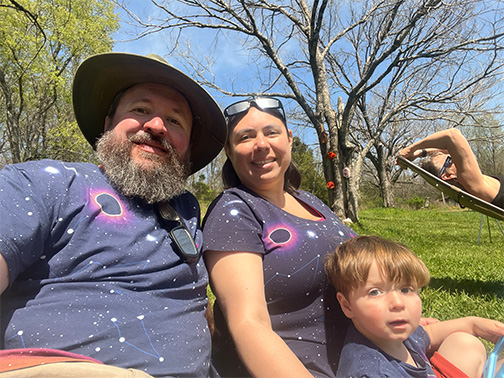 Bob and Roseana Burick with a child during solar eclipse 2024 at their farm in Missouri