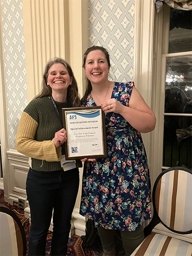 Stacy Furgal with her college showing her Special Achievement Award from Northeastern Division of the American Fisheries Society