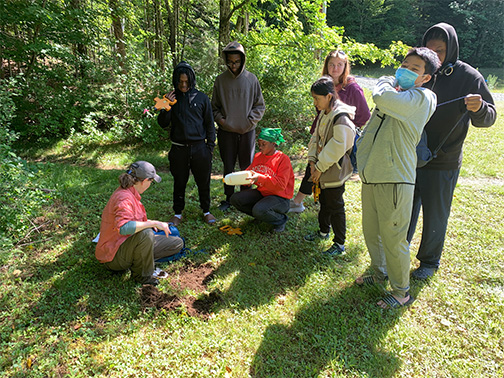 Participants learn about invasive earthworms ecologist and Associate Director Dr. Stacy McNulty ('97 & '23) at ESF's Newcomb Campus.