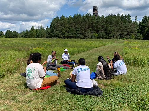 Students of Timbuctoo Institute siting in a field